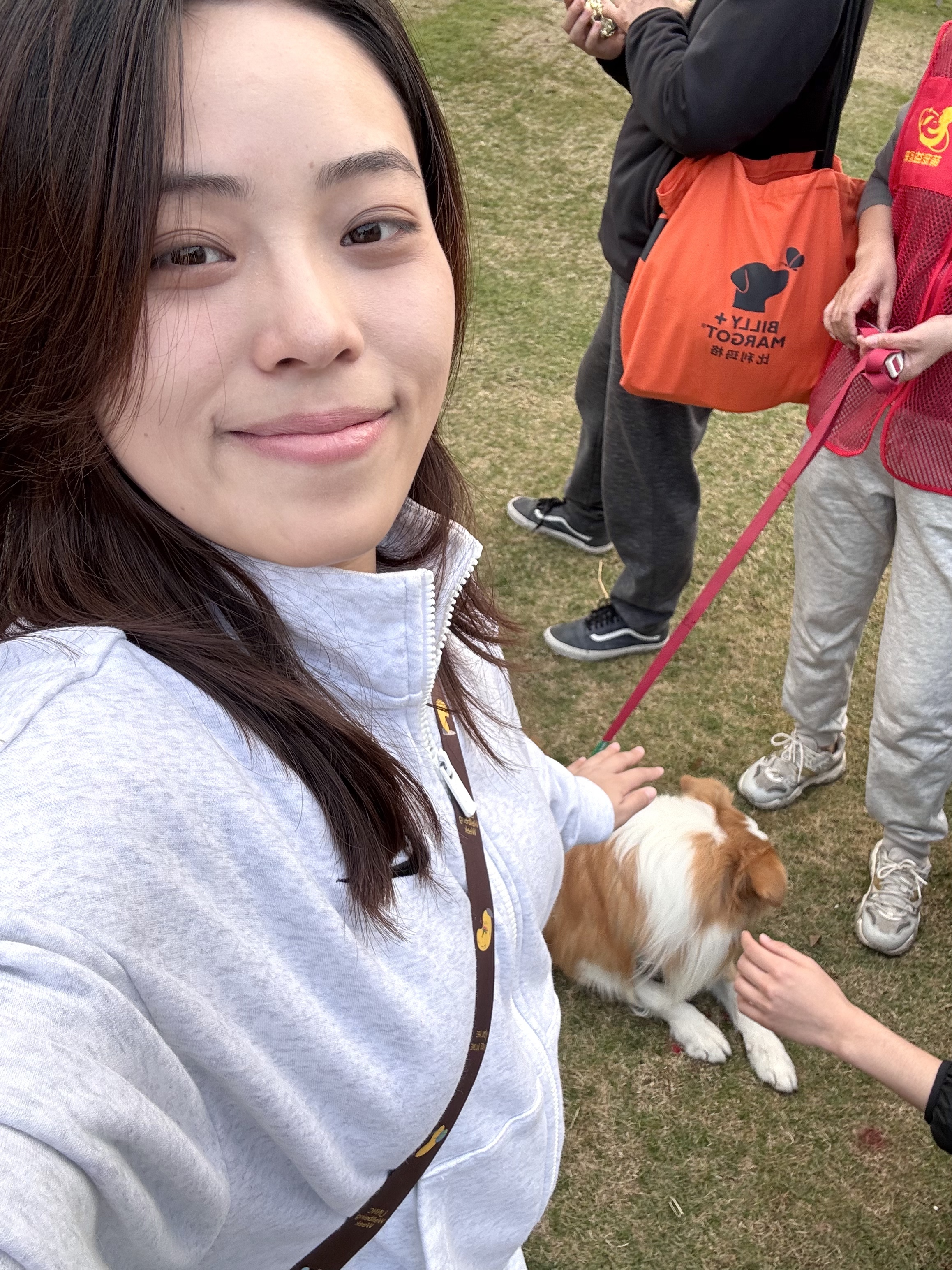 Gloria and friend sitting with a dog